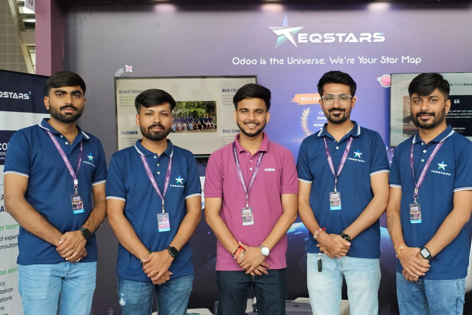 Five people in TeqStars and Odoo shirts at the TeqStars exhibition booth
