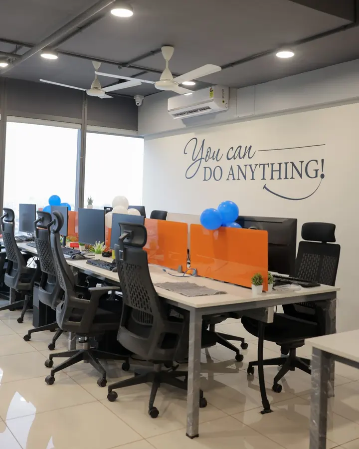 The TeqStars office: rows of desks under a 'You can do anything!' wall sign