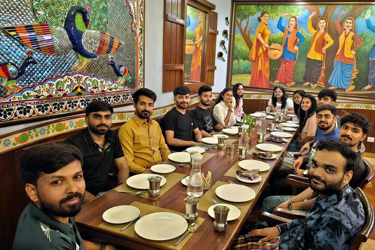 The TeqStars team seated along a long restaurant table for a team meal