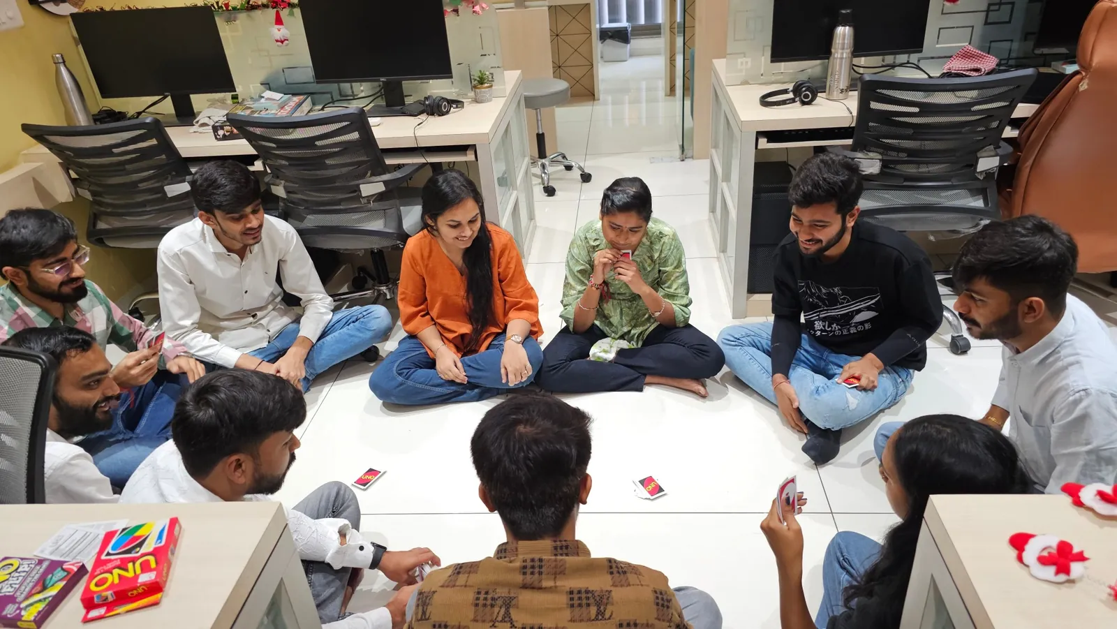 The TeqStars team playing UNO on the office floor